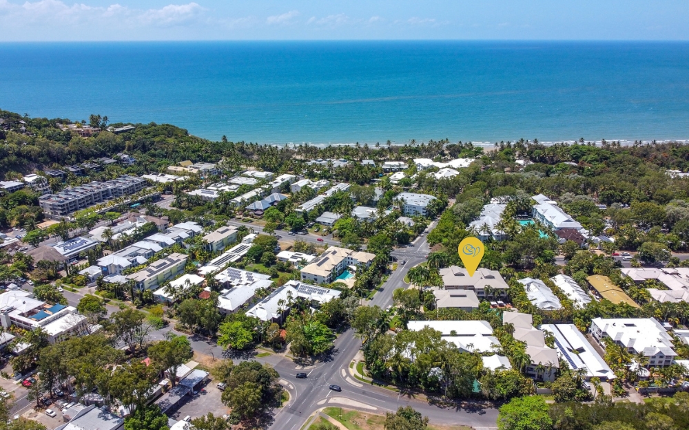 Aerial view of Port Douglas showing Cayman Villas surrounded by tropical gardens, just a short walk from Four Mile Beach and Macrossan Street.