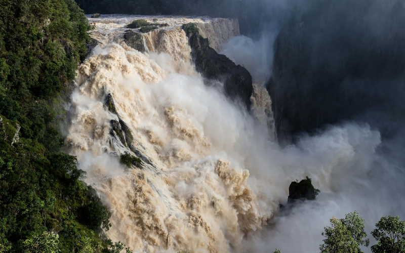 Powerful Barron Falls cascading through the rainforest near Kuranda in Tropical North Queensland.